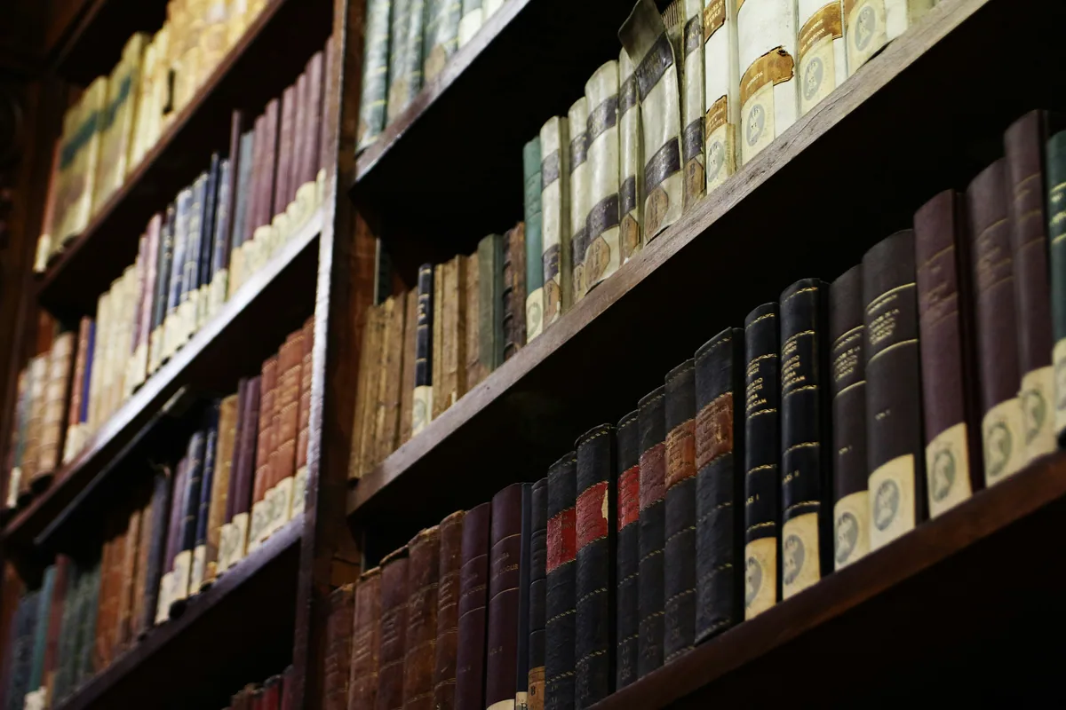 Old books on library shelves in Milan
